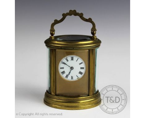 A late 19th century French brass oval carriage time piece, enamel dial with Roman numerals, (damage to dial), and back plate 