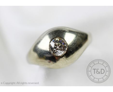 A diamond set white metal ring, designed as a central old cut diamond (of approx 0.45ct) 'gypsy' set within white metal, unma