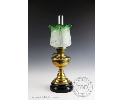 A late Victorian oil lamp with baluster brass stem supporting a green frosted florally etched shade 59cm high (as found) COND