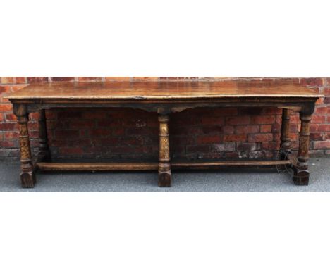 An 18th century style oak refectory type table, with four plank top, on turned legs and block feet, 74cm H x 239cm W x 74cm D