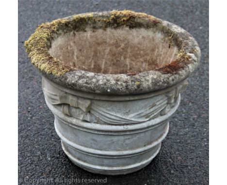 A reconstituted stone circular garden planter with garland and bow decoration, 54cm diameter