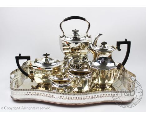An early 20th century silver plated five piece tea service, including kettle on stand with burner, with a pierced silver plat