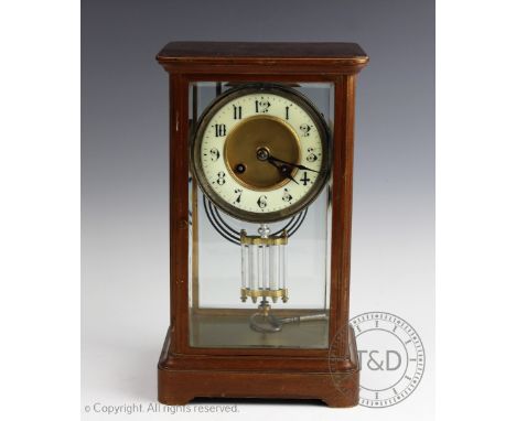 An early 20th century French four glass mantel clock, the lacquered brass case set with bevelled glass panels and enclosing a