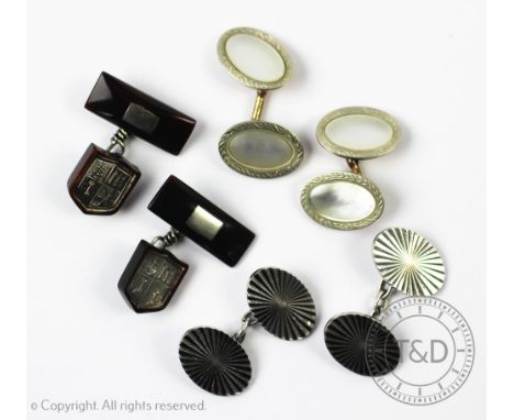 Three pairs of cuff links, to include; a pair of tortoiseshell and silver inlaid cufflinks depicting a shield and crest, a pa