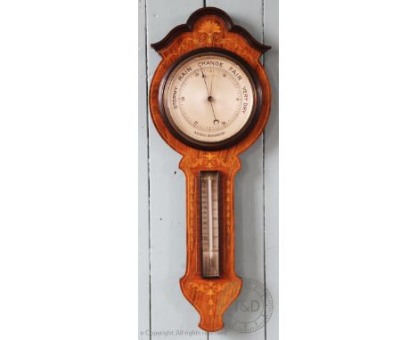 An Edwardian inlaid walnut wheel barometer, 77cm H, and a smaller carved barometer, 23cm diam (2)