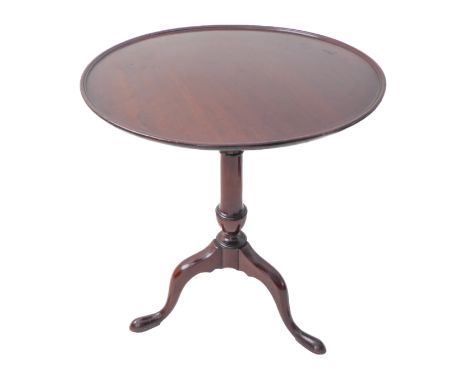 A Georgian circular dish-topped mahogany tilt-top occasional table; turned stem and on tripod base with elongated pad feet, w