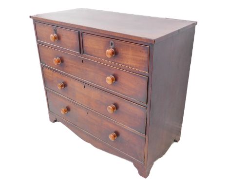 An early 19th century mahogany chest; two half-width over two full full-width graduated drawers, shaped frieze and raised on 