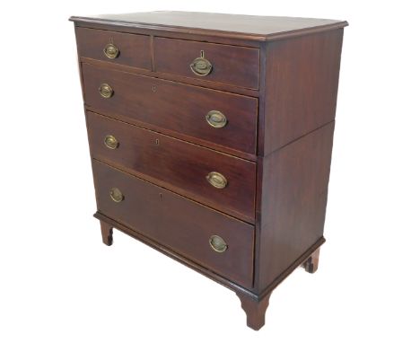 A George III period two-part mahogany chest: the rosewood crossbanded moulded top above two half-with and three full-width gr