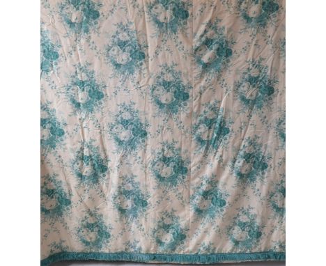 A pair of curtains in a cream and green patterned silk effect damask with a green floral print, thick green fringed edging, g