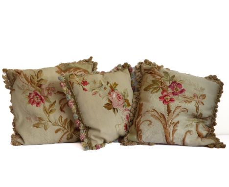 A pair of cushions in an antique tapestry-effect floral fabric edged with pom-pom braid (40cm square) and another similar cus