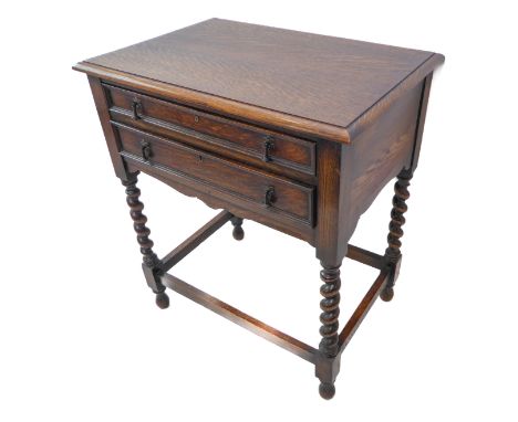 A 1930s oak two-drawer canteen table containing a mixed set of silver-plated flatware and cutlery to include teaspoons, table