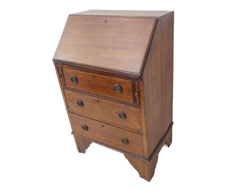 An Edwardian mahogany and chequer strung writing bureau of slim proportions: the one piece angular fall opening to reveal sma