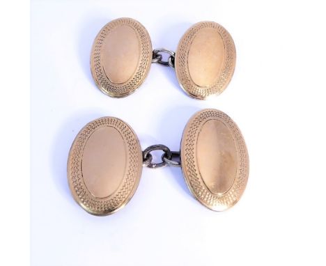 A pair of 9-carat yellow-gold on solid silver oval cufflinks, engine-turned borders