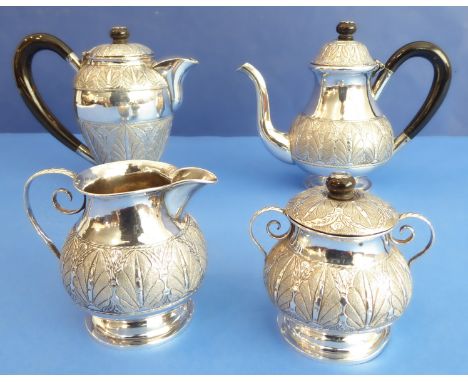 An early 20th century Indian silver / white-metal service comprising teapot, coffee pot, milk jug and lidded sugar basin, mar