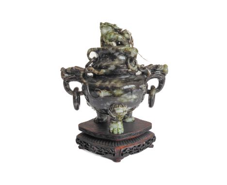 A carved Chinese hardstone two-handled tripod censer and cover, the cover with a mythical beast finial above three lugs with 