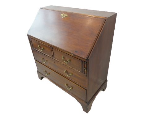A late 18th century mahogany writing bureau: the angular fall opening to reveal fitted interior with drawers and pigeonholes 