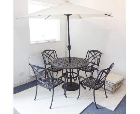 A garden set comprising circular light-metal table, four chairs with cushions and parasol