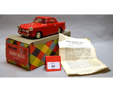 A boxed Tri-ang Minic M021 battery operated Triumph Herald plastic car model in 1:20 scale. Model appears G+/VG with clean ba