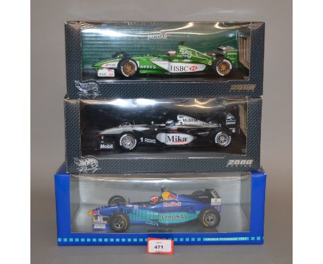 Five boxed diecast Racing Car models in 1:18 scale, including two from the Hot Wheels 2000 Racing series, a Quartzo Lotus 49B