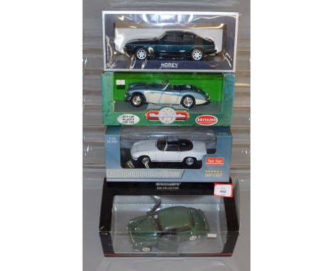 Four boxed diecast model cars in 1:18 scale, including a Britains Austin Healey 100-Six, a Norev Ford Capri, a MInichamps Mor