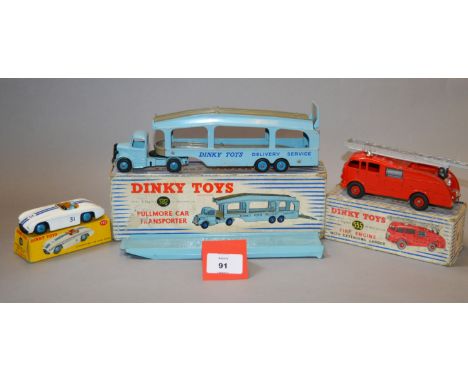 Three Dinky Toys: 582 Pullmore Car Transporter with light blue car transporter; 555 Fire Engine in red with silver extending 