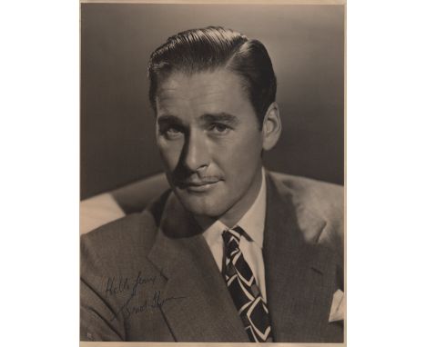  FLYNN ERROL: (1909-1959) Australian Film Actor. An excellent vintage signed 11 x 14 photograph of Flynn seated in a head and