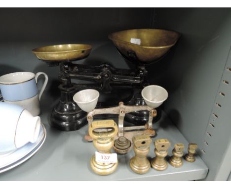 A vintage balance scale set and graduated brass weights