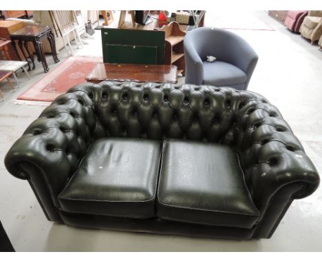 A green leather Chesterfield style sofa couch