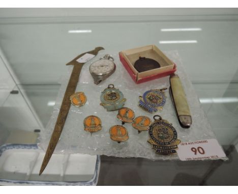 A selection of vintage curios and enamel badges 