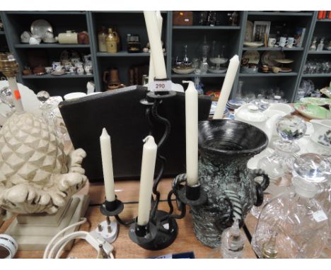 A vintage wrought iron candle stick and similar decoration