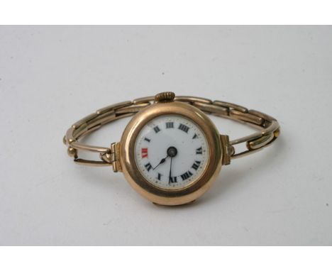 A 9ct gold vintage lady's watch with an enamel dial and expanding strap.