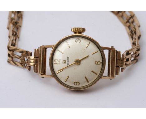 A ladies 9ct gold Tissot watch and strap.