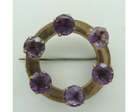 Victorian circular gold brooch set with with six large amethysts, lacking pin catch, unmarked, D: 42 mm, 11.7g. UK P&amp;P Gr