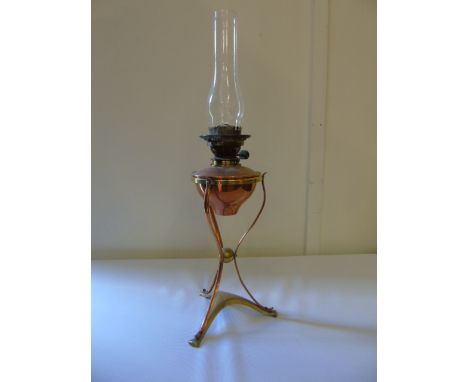 Art nouveau copper and brass oil lamp raised on 3 sinuous legs