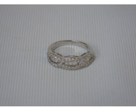 18ct white gold ring with 24 baguette cut diamonds in 3 rows each surrounded by a total of 36 round cut diamonds