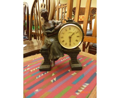 Juliana mantel clock with lady seated reading a book (believed in working order)