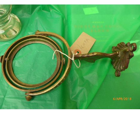 Small glass oil lamp mounted on brass wall bracket