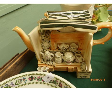 Light green decorative teapot with raised floral decoration, white ground cylindrical vase and a brown Port Merion comical te