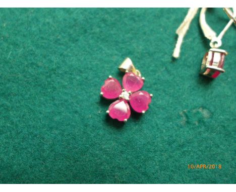 A ruby pendant and earrings, set in .925 sterling silver in multi-coloured presentation box