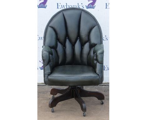 Dark green leather upholstered office chair, button back and nailed upholstery, on wooden four leg base, with casters, 106cm 