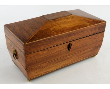 A Regency kingwood twin division tea caddy of sarcophagus form, with twin lion ring handles and brass bun feet.  Width 30cm.C