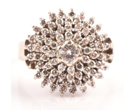Diamond cluster ring, central round brilliant cut diamond weighing an estimated 0.20 carat, surrounded by four tiers of singl
