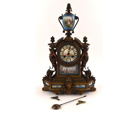 A late 19th century French Ormolu and porcelain mounted mantel clock, with urn finial and painted porcelain dial.  The body i