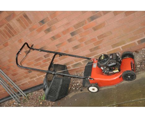 A CHAMPION CLASSIC 35 PETROL LAWN MOWER with a Briggs and Stratton engine and grass box (motor pulls freely but hasn't been s