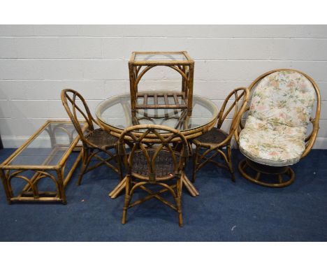 A WICKER CONSERVATORY SUITE, comprising a circular glass top table, four chairs, a swivel egg chair, coffee table and a lamp 