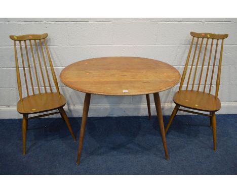 AN ERCOL BLODE ELM AND BEECH OVAL TOPPED DINING TABLE, on cylindrical tapering legs united by a dowel under shelf, width 100c