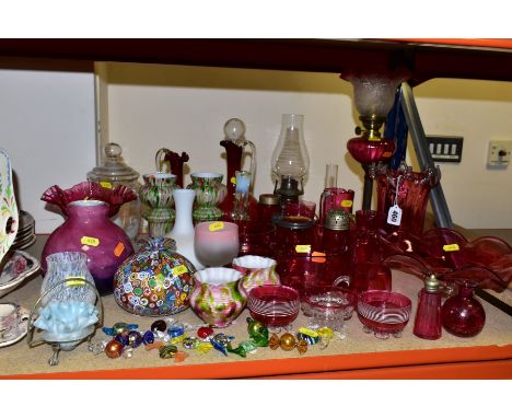 A GROUP OF 19TH AND 20TH CENTURY CRANBERRY AND OTHER COLOURED GLASSWARE, including an early 20th century brass based oil lamp