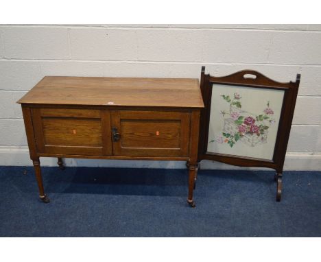 AN EARLY TO MID 20TH CENTURY GOLDEN OAK TWO DOOR WASHSTAND, together with an oak firescreen (2)