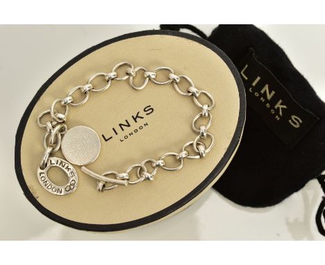 A WHITE METAL LINK BRACELET, the oval link bracelet, suspending two circular charms, the first of a plain polished design, st
