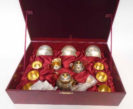 RUSSIAN SILVER TEA SERVICE, with gilt and niello banded detail, comprising a six place setting in fitted case, total weight 6